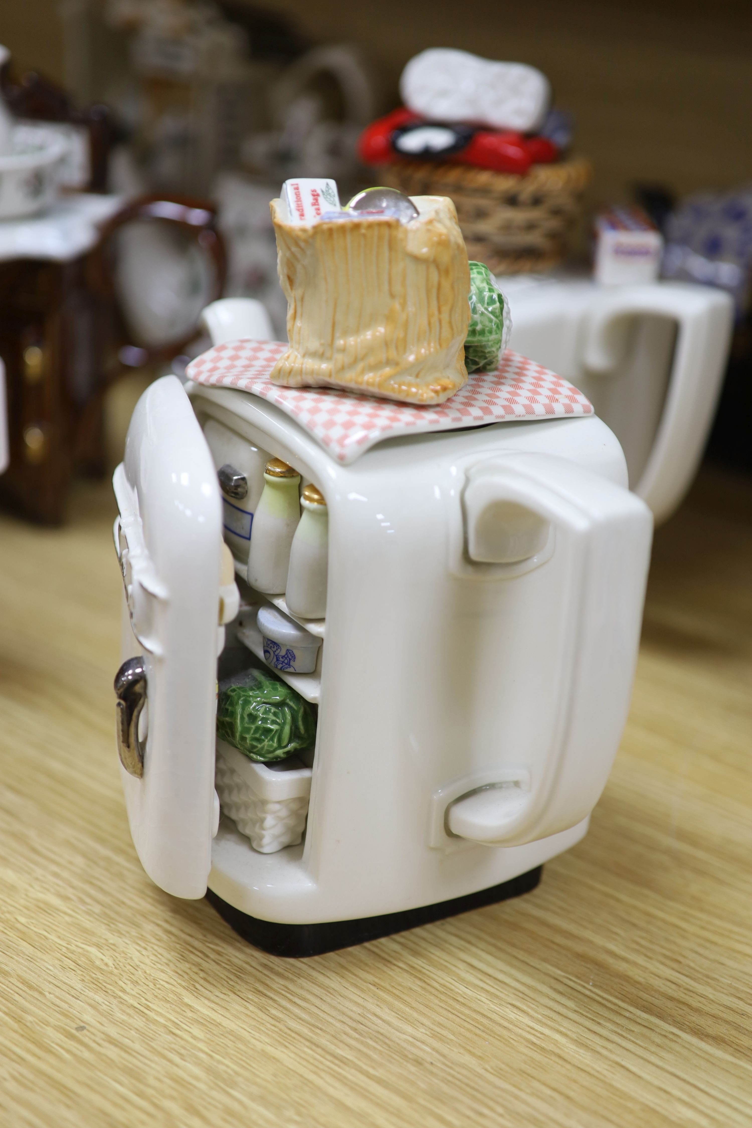 A collection of thirteen Portmeirion and Cardew novelty teapots, including dresser, sewing machine and kitchen range examples